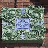 Detail, green and blue glazed terracotta corner ornament, second story arcade
