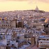 Aerial view over Paris, looking north over rooftops towards Montmartre at dusk