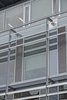Detail, curtain walling with custom louvered window vents, bolted glass assemblies and brise soleil manufactured by Schuco