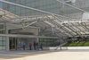 Detail, plaza entrance to the four story annex with "folding" metal sun screen anchored in a raised and tilted strip of lawn, at right