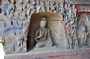 Buddha in niche surrounded by figures, mountains and waves