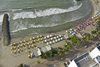 General view: Aerial view of Playa De Bocagrande, looking down, depicting beach umbrellas and surf breaker walls
