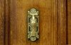 A door handle on a wood door in Paris, France