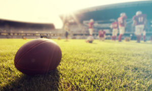 Close,Up,Of,An,American,Football,On,The,Field,,Players