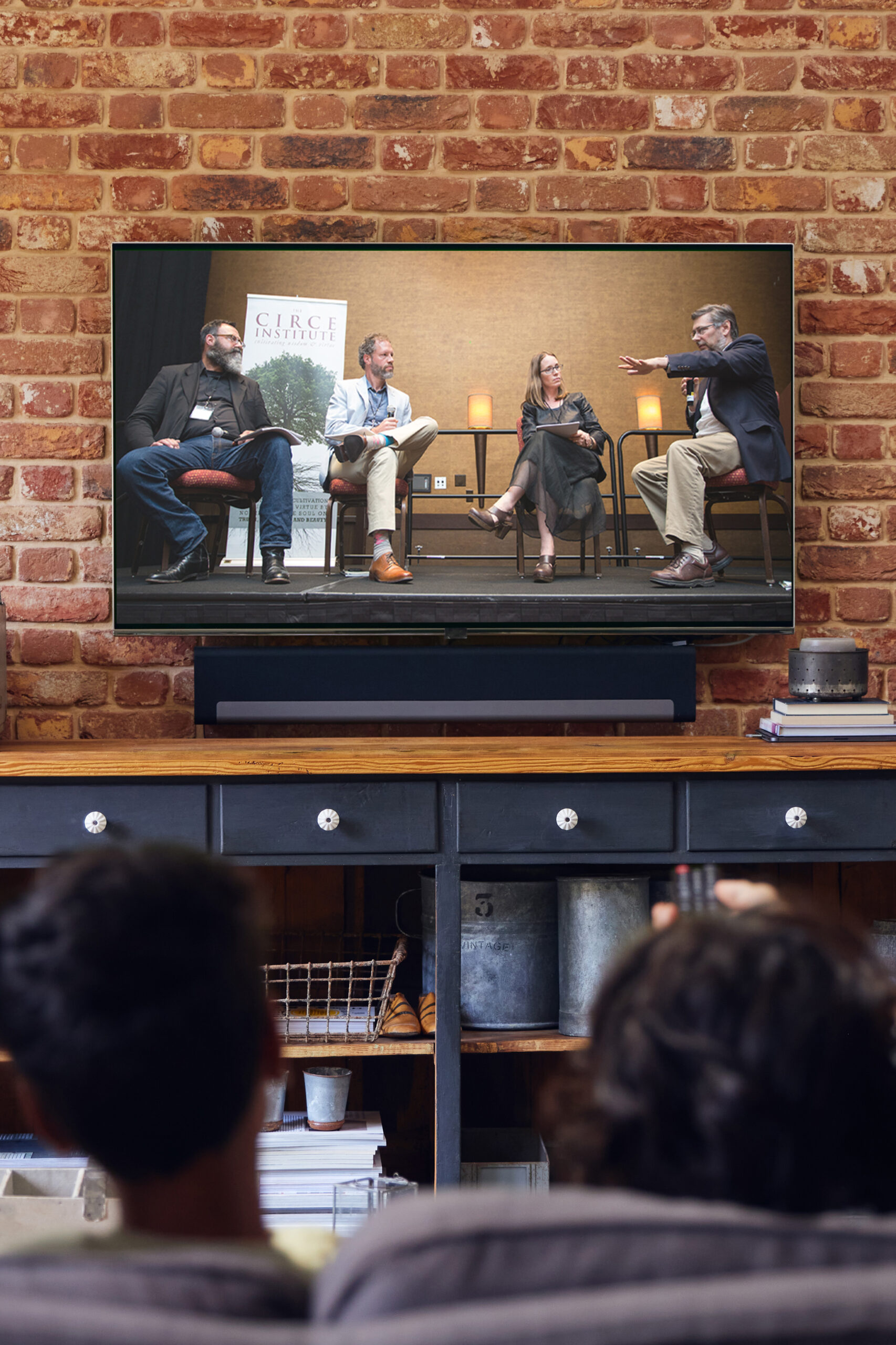 Family watching TV at home on sofa.