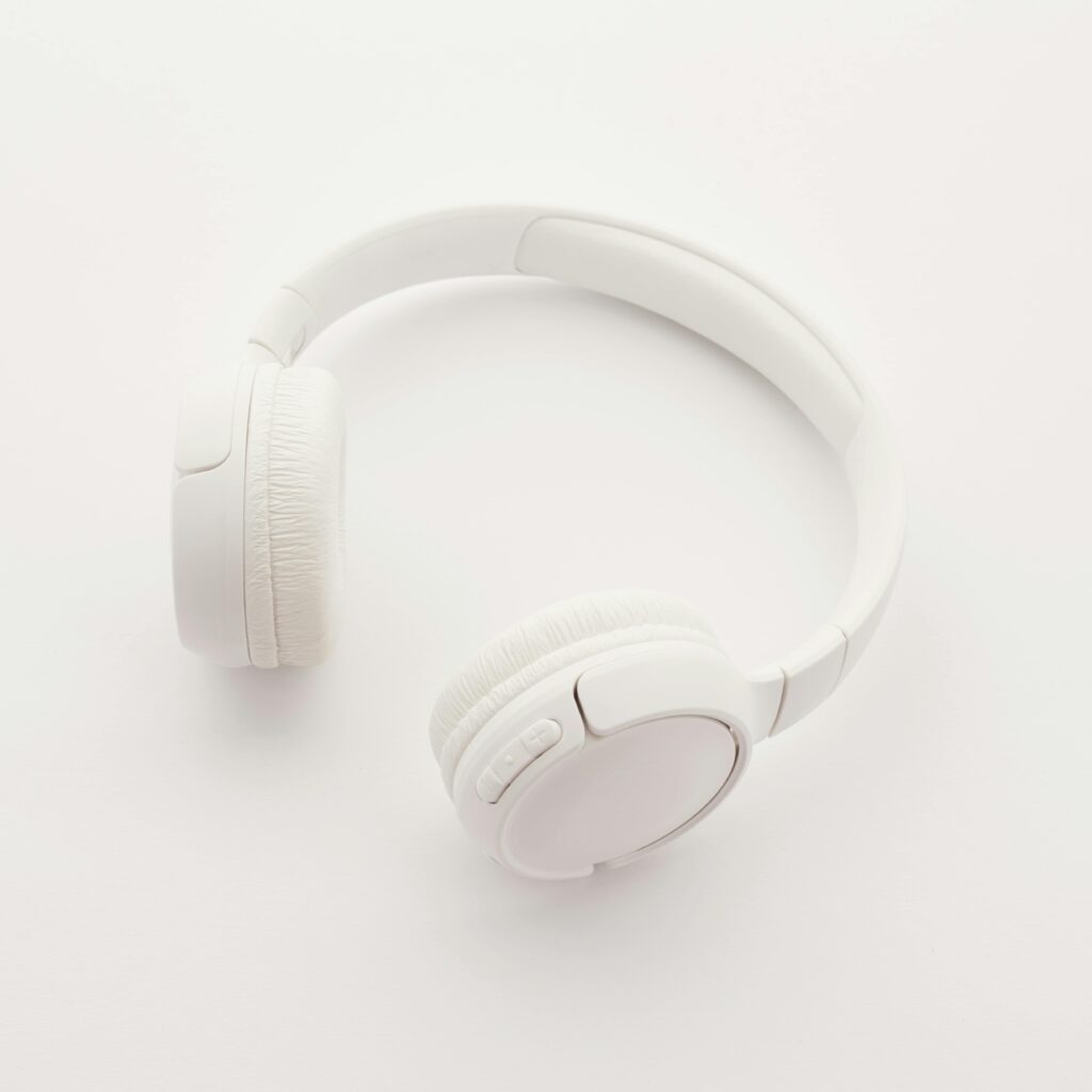 Sleek overhead view of modern white wireless headphones on a clean white background.