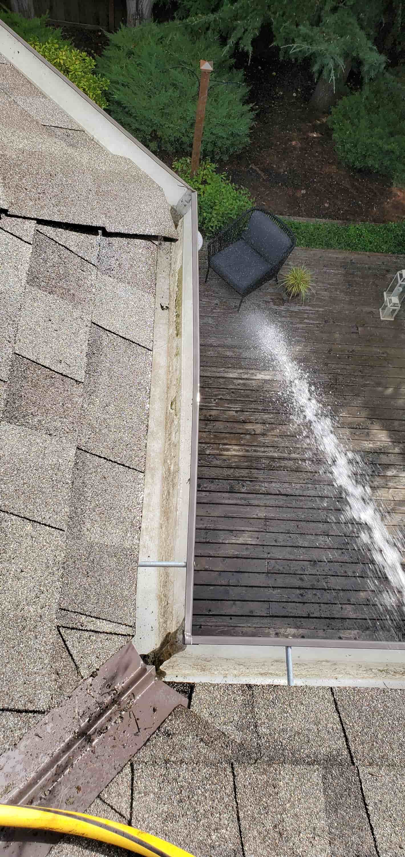 clean gutter with pressure washer