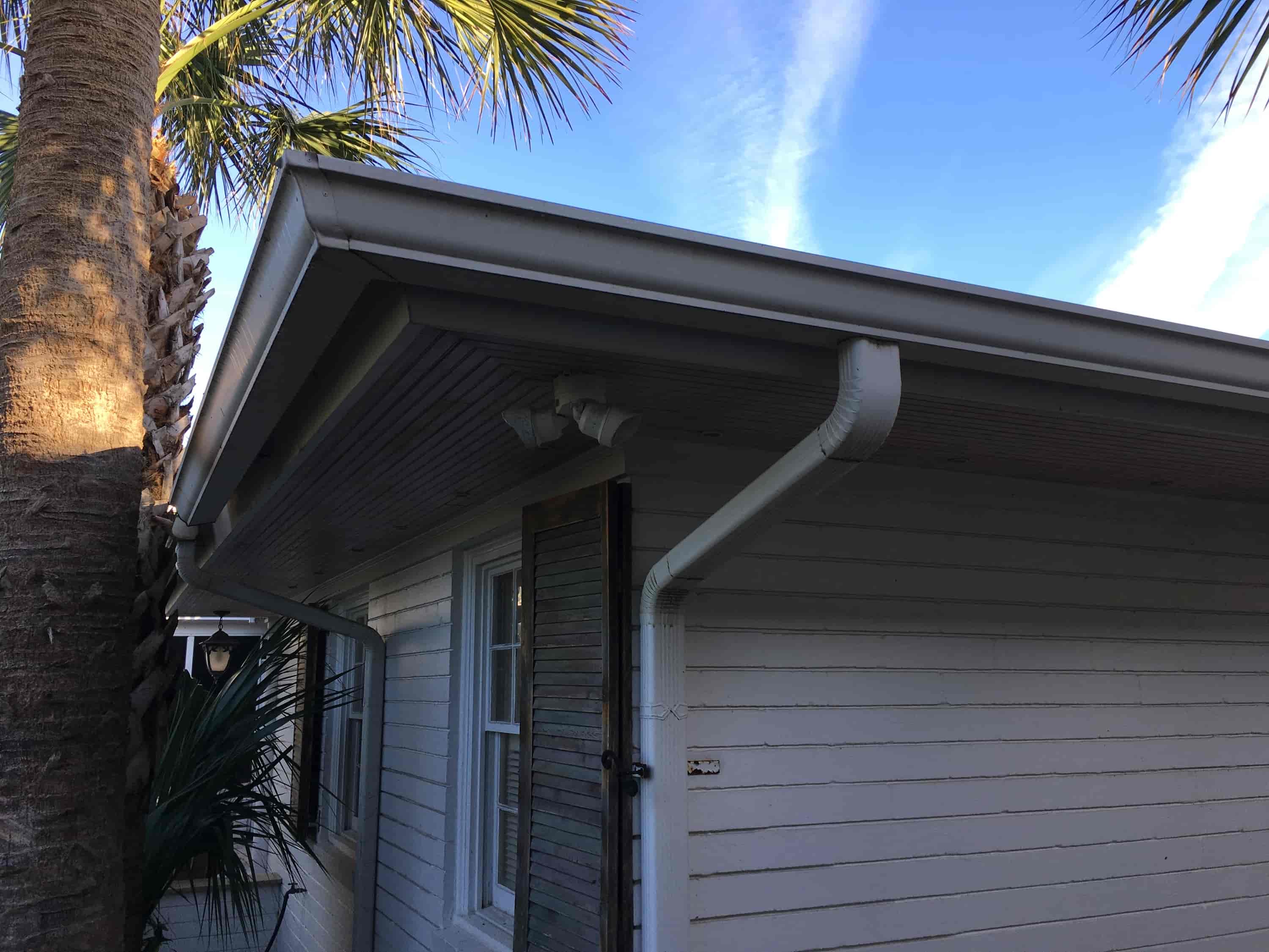 cleaning gutters with gutter guards