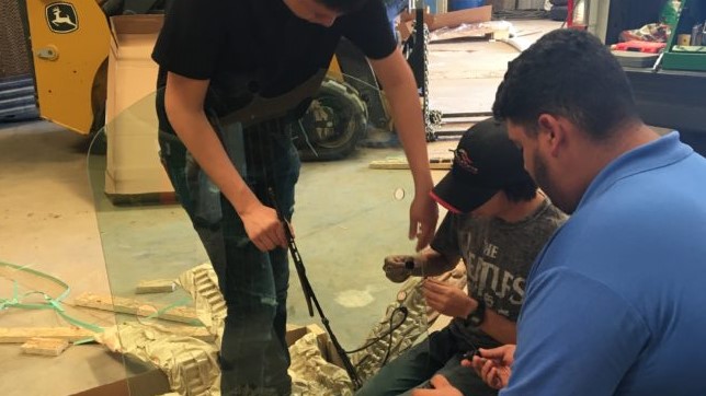 students repair farm equipment