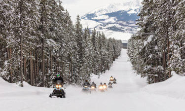 Snowmobiles riding the park road