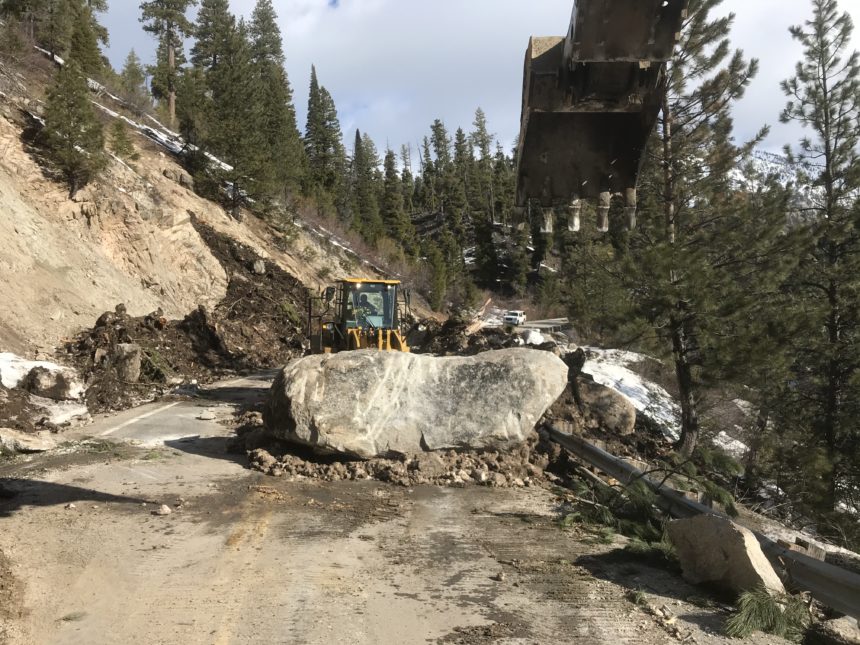 Highway 21 cleanup21_This boulder was buried within one of the larger slides. Travel lanes are 12 feet wide.