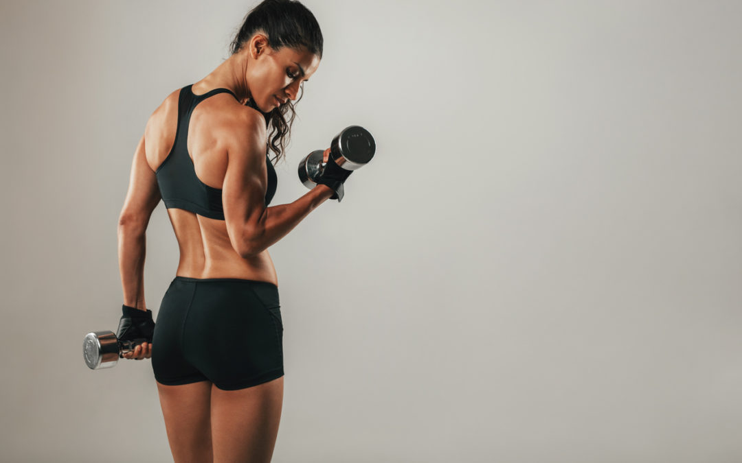 Fit Strong Young Woman Lifting Weights