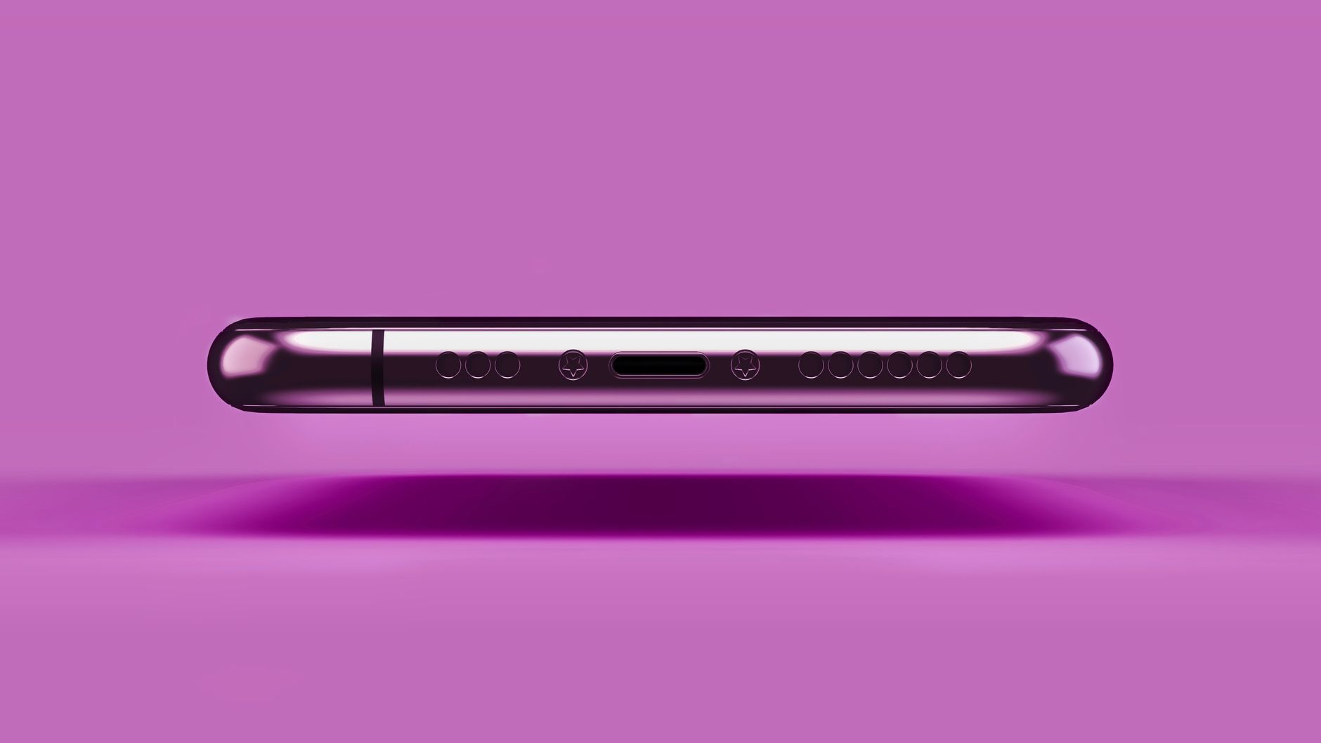 Celular não carrega: o que fazer e como descobrir a causa A sleek metallic smartphone resting on a vibrant pink background in a studio setting.
