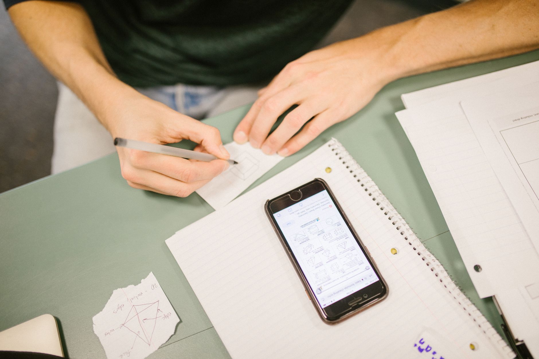 Pessoa segurando um celular com uma tela de teste de desempenho sobre a mesa