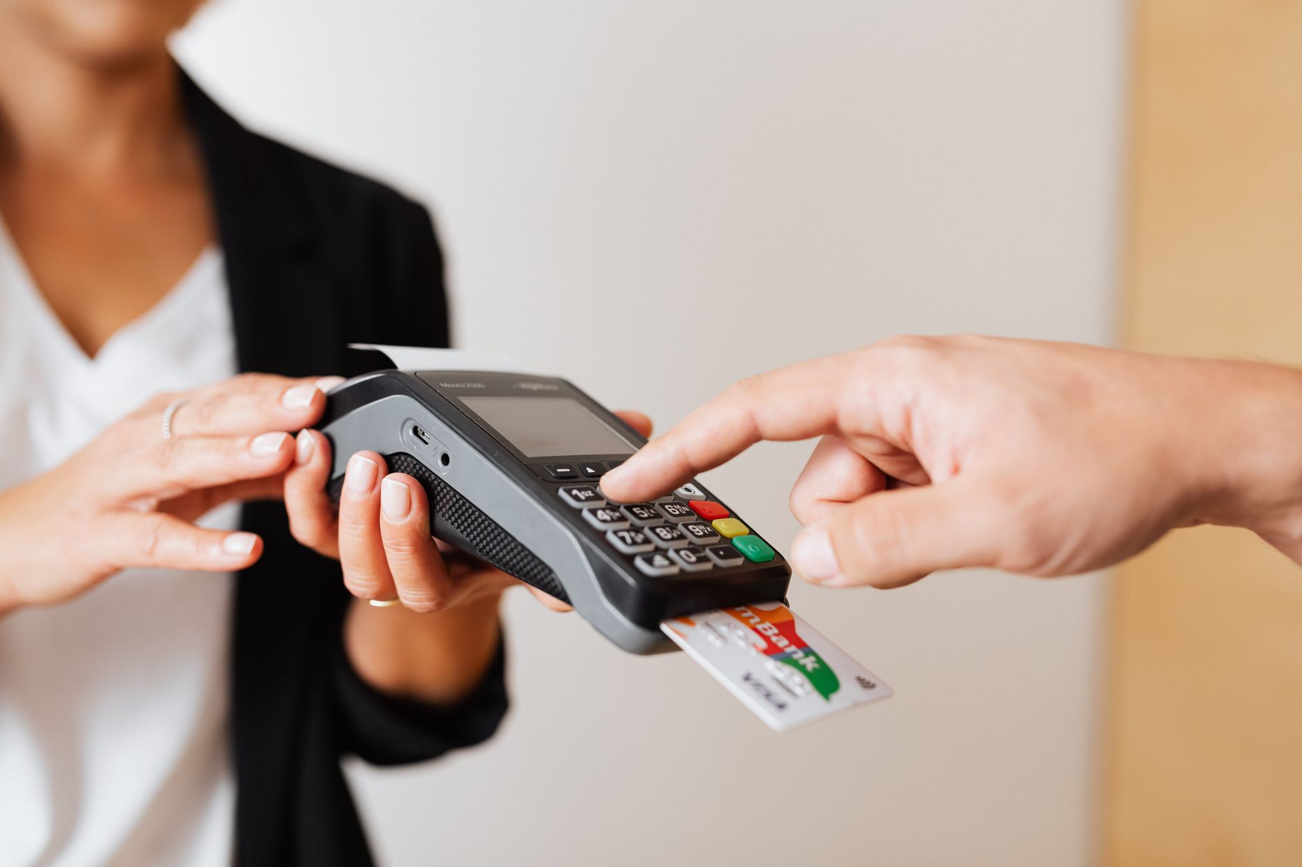 A customer using a contactless payment terminal for secure and cashless transactions indoors.