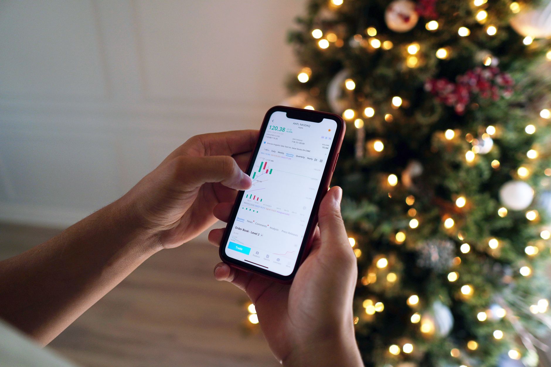 Pessoa analisando gráfico de cotação do dólar na tela de um smartphone.