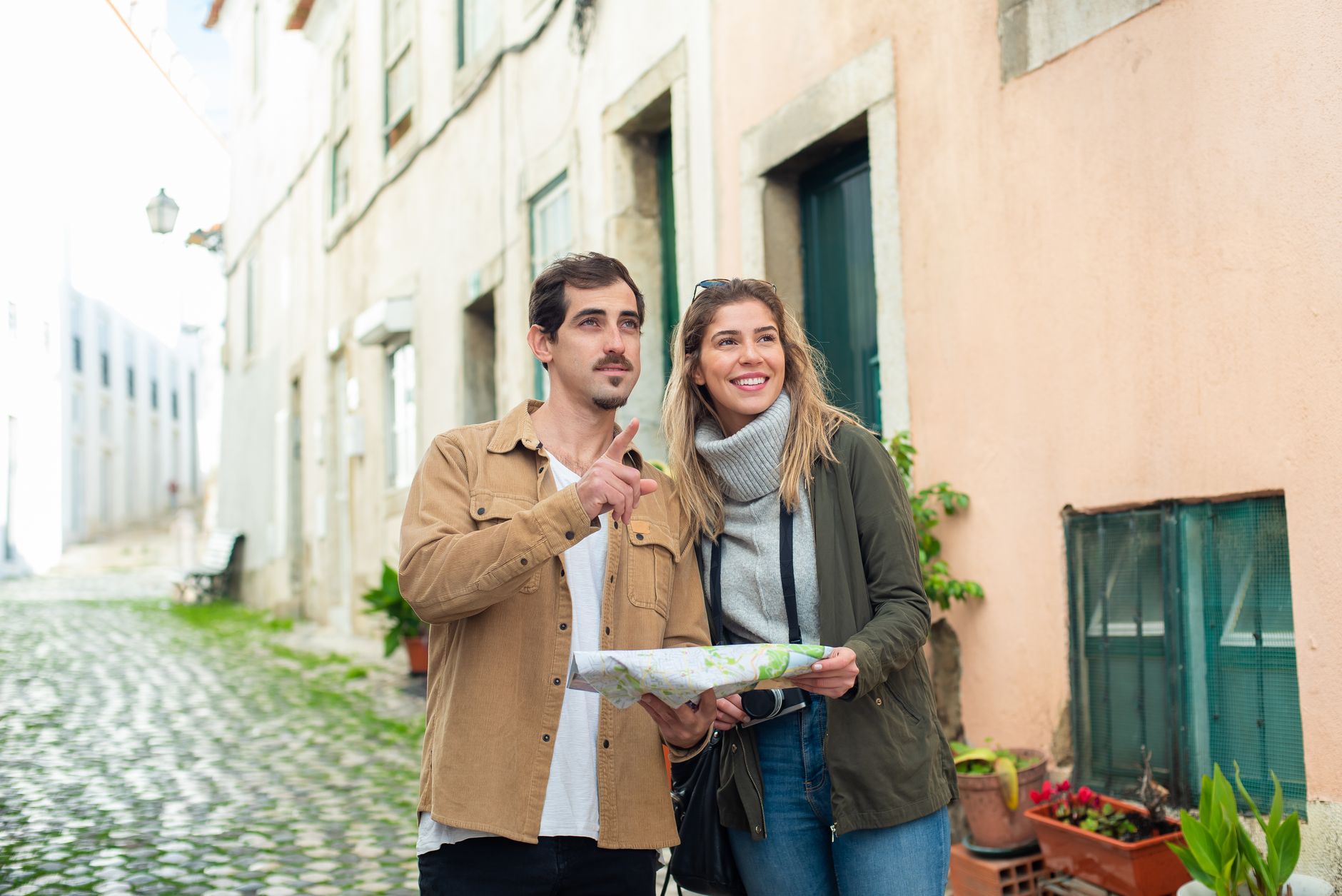 Viajante consultando um mapa da cidade europeia com um café sobre a mesa.