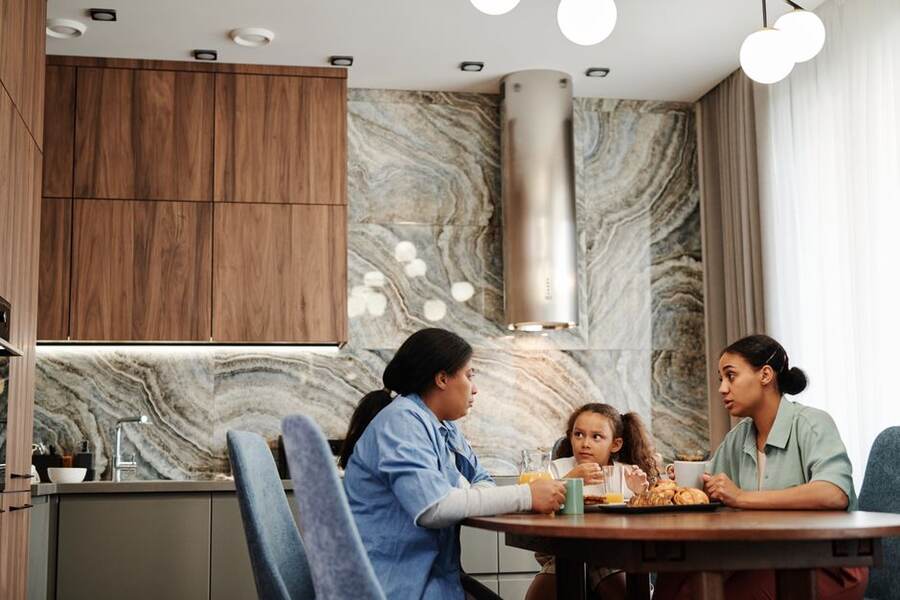 Família conversando sobre o orçamento na mesa da cozinha