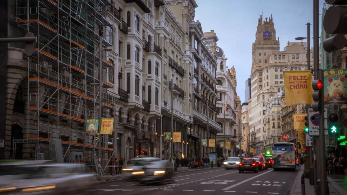 Rua movimentada no centro de Madri com prédios históricos