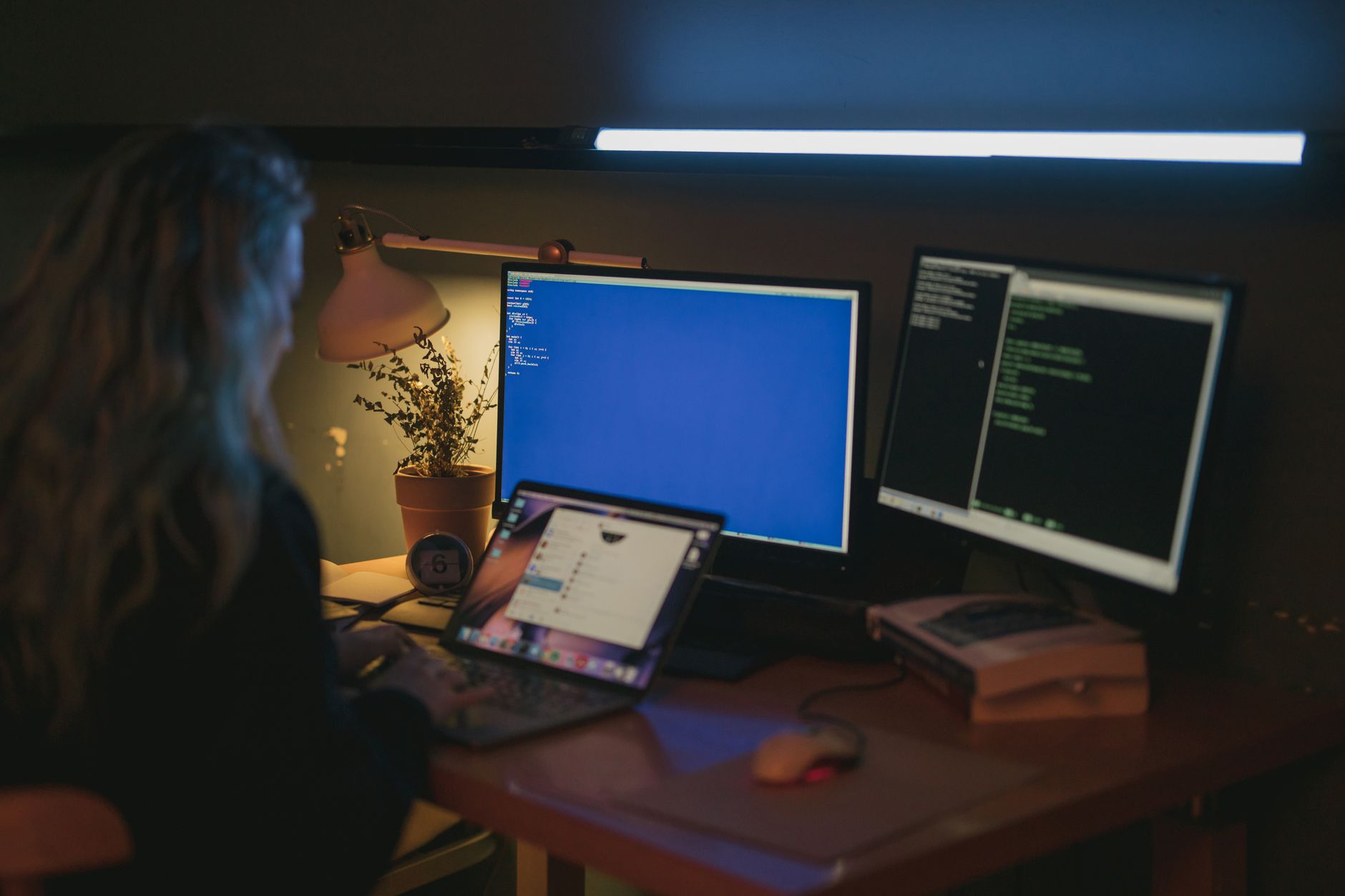 Profissional trabalhando em casa com notebook e documentos protegidos sobre a mesa