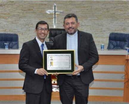 Vereador Sérgio entregou o título de cfidadania ao padre Carlos Adriano (Foto: Comunicação Câmara) Vereador Sérgio entregou o título ao padre Carlos Adriano (Foto: Comunicação Câmara)