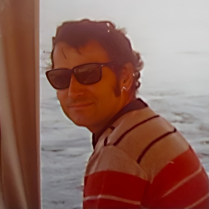 A headshot of John Kempo wearing sunglasses.