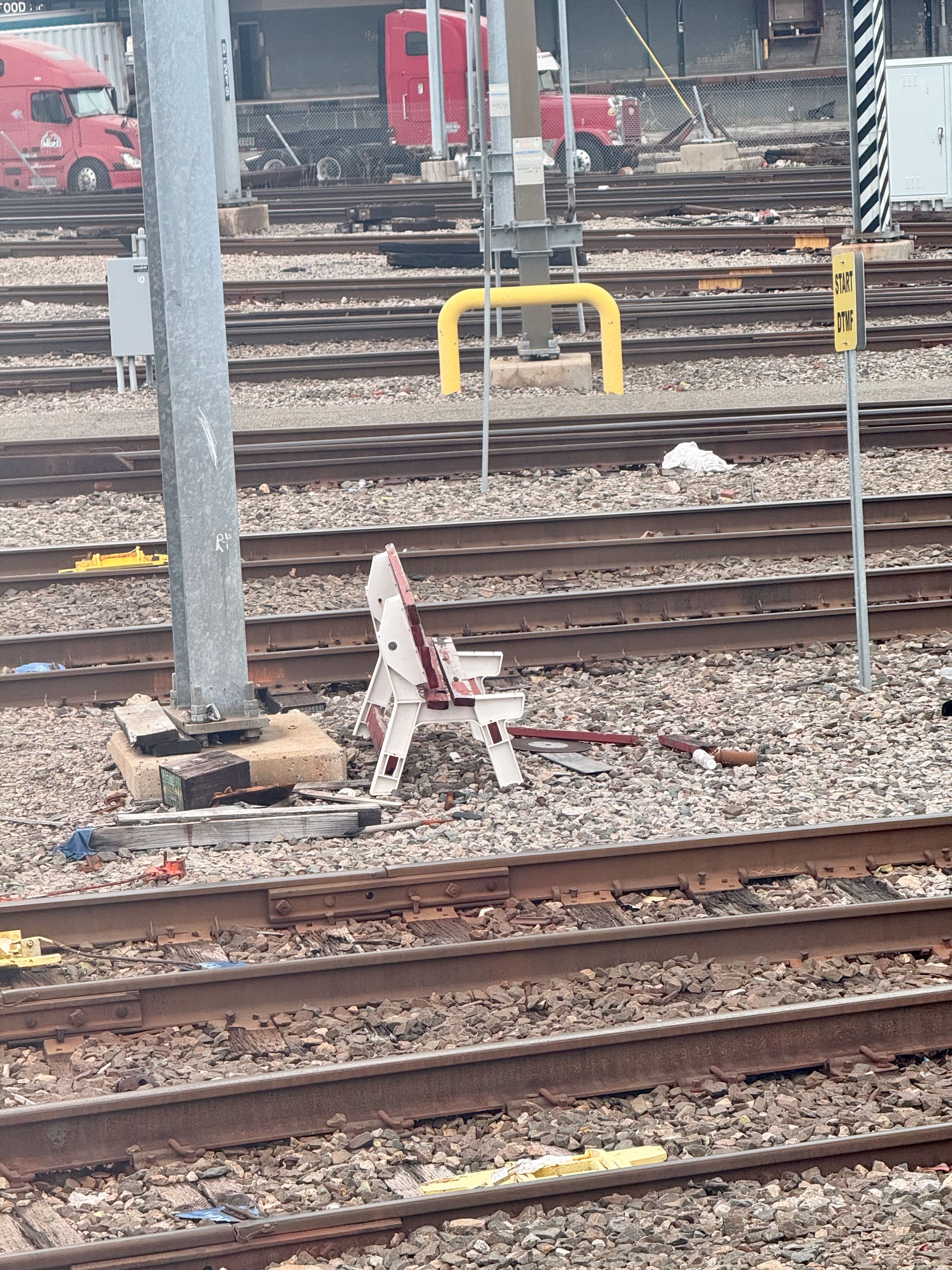 A plastic and wooden bench in the middle of a busy railroad exchange near South Station