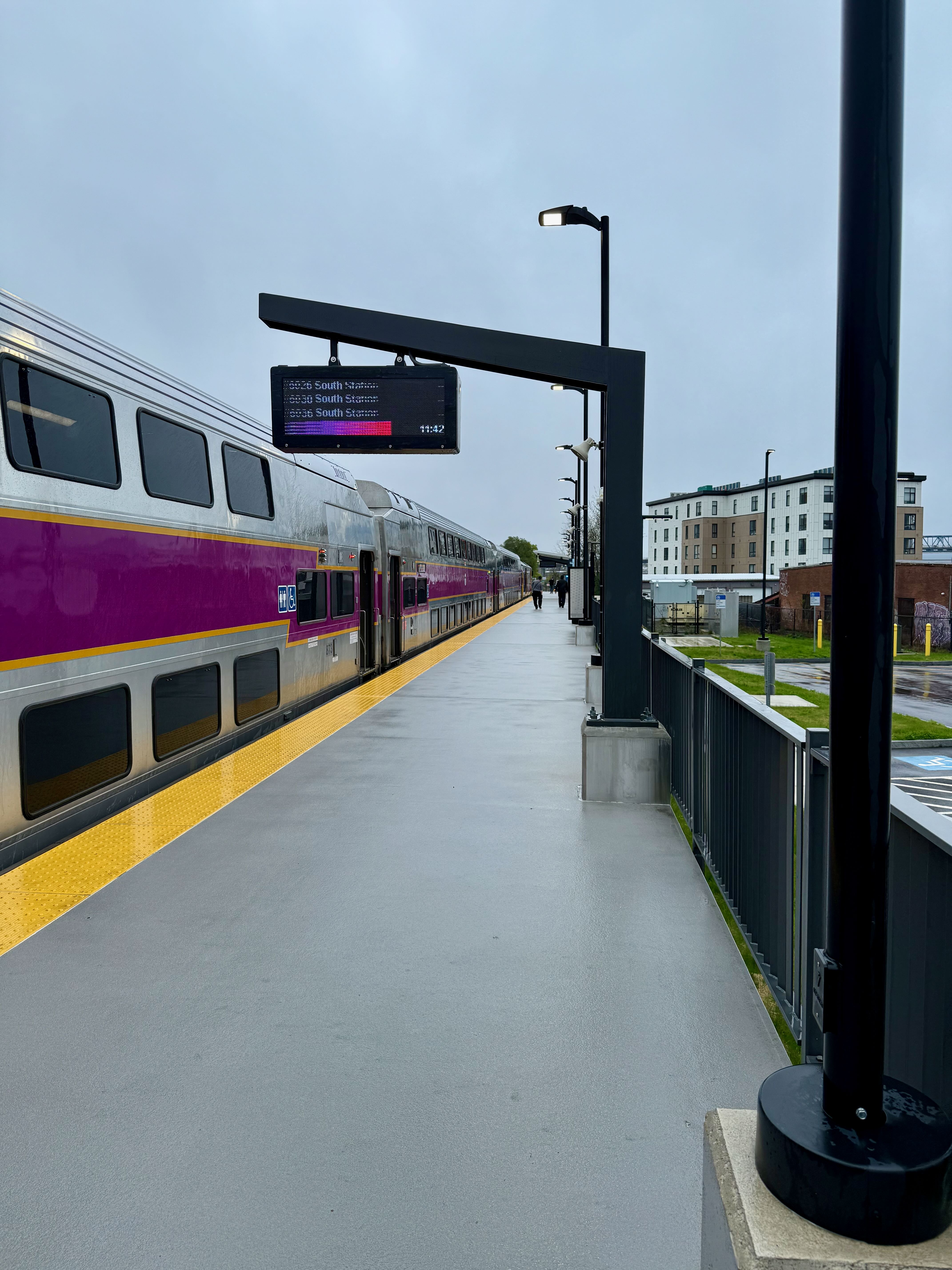The purple and silver view of an MBTA Commuter Rail train