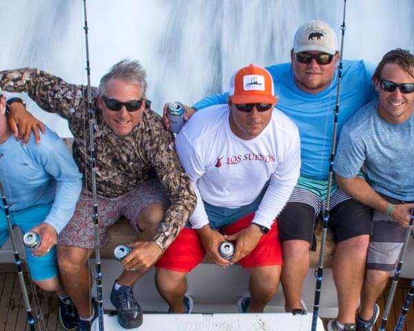 Fishers smiling and holding fishing rods