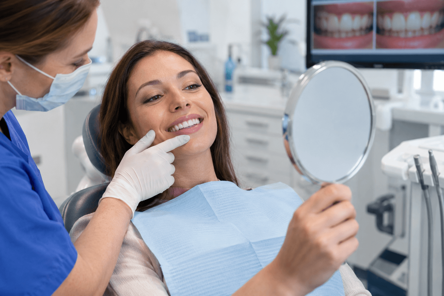 Dental professional reviewing a patient's smile and teeth whitening result in a clinic